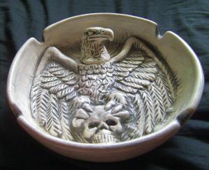 Eagle sitting on skull ashtray